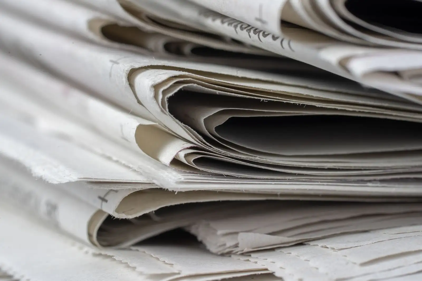 Pile de journaux pliés en gros plan, image de la couverture médiatique des marques de célébrités
